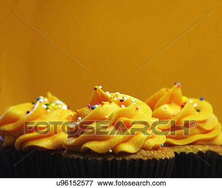 Trio Of Orange Iced Cupcakes In A Row View Large Photo Image Stock Photo - Trio Of Orange Iced Cupcakes In A Row. Fotosearch