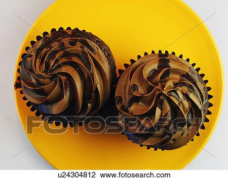 Two Chocolate Cupcakes On An Orange Plate View Large Photo Image Stock Image - Two Chocolate Cupcakes On An Orange Plate. Fotosearch