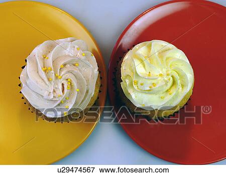 Two Iced Cupcakes Placed Like Eyes On Plates View Large Photo Image Stock Photo - Two Iced Cupcakes Placed Like Eyes On Plates. Fotosearch