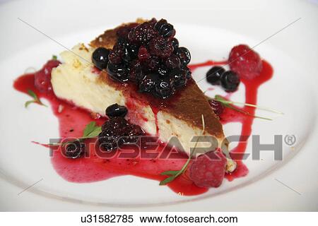 Stock Photography - Vanilla Cheesecake With Berries And Basil. Fotosearch