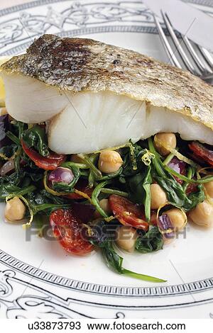 A baked fillet of pollock on a bed of garbanzo beans and spinach View Large Photo Image Stock Image - A baked fillet of pollock on a bed of garbanzo beans and spinach. Fotosearch