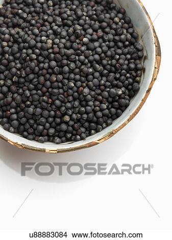 Picture - A bowl of black mustard seed on a white background. Fotosearch