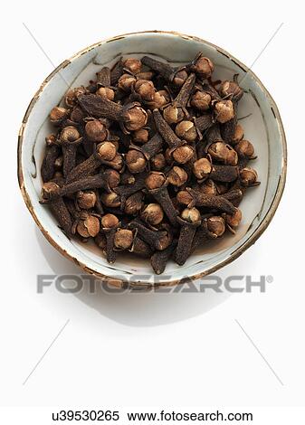A bowl of cloves on a white background View Large Photo Image Stock Photography - A bowl of cloves on a white background. Fotosearch