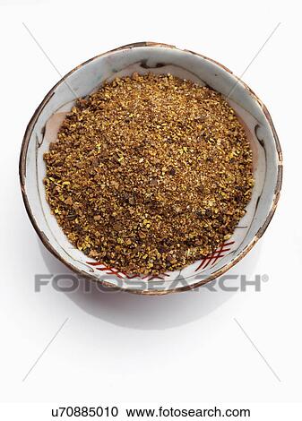 Stock Image - A bowl of Jamaican Jerk spice on a white background. Fotosearch