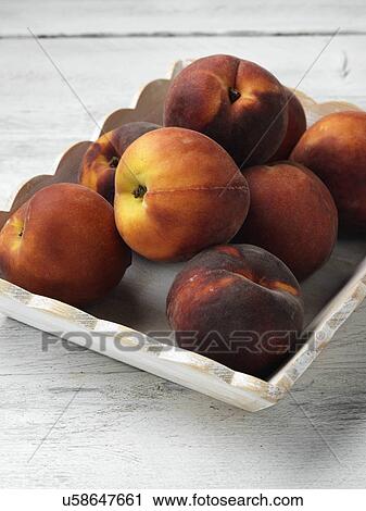 Stock Image - A bowl of ripe peaches. Fotosearch