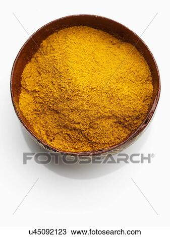 Stock Image - A bowl of turmeric on a white background. Fotosearch