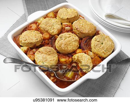 A casserole dish of roast vegetable stew with cobblers View Large Photo Image Stock Image - A casserole dish of roast vegetable stew with cobblers. Fotosearch