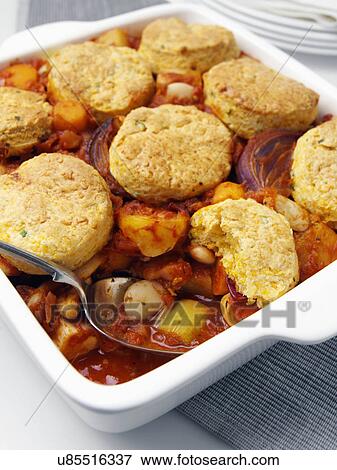 A casserole dish of roast vegetable stew with cobblers View Large Photo Image Stock Photo - A casserole dish of roast vegetable stew with cobblers. Fotosearch