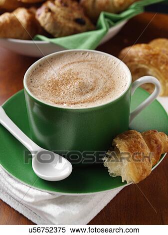 Stock Photography - A cup of cappuccino coffee and croissant. Fotosearch
