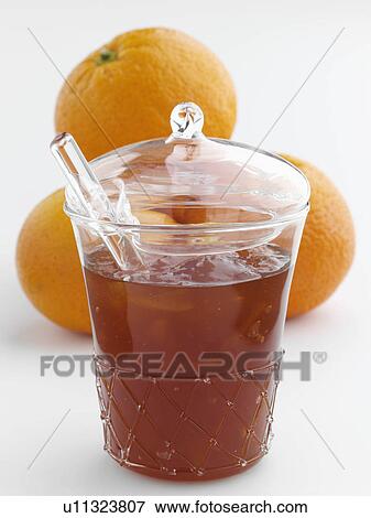 A glass jar of home made marmalade with a spoon and oranges View Large Photo Image Stock Photo - A glass jar of home made marmalade with a spoon and oranges. Fotosearch