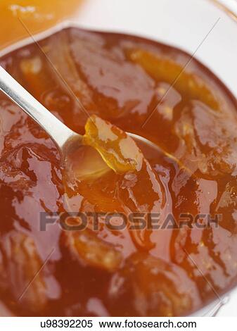 A glass jar of home made marmalade with a spoon View Large Photo Image Stock Photography - A glass jar of home made marmalade with a spoon. Fotosearch