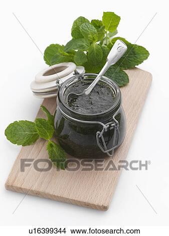 A jar of mint sauce with a spoon and fresh leaves View Large Photo Image Picture - A jar of mint sauce with a spoon and fresh leaves. Fotosearch