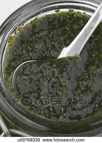 A jar of mint sauce with a spoon View Large Photo Image Stock Photo - A jar of mint sauce with a spoon. Fotosearch