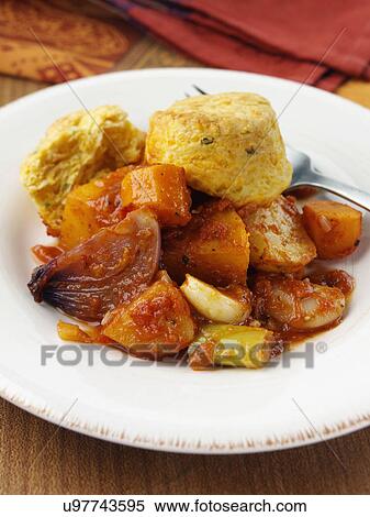 Stock Photography - A plate of roast vegetable stew with cobblers. Fotosearch