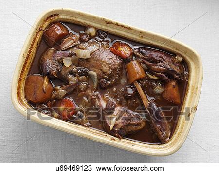 Stock Image - A rustic pot of rabbit stew. Fotosearch