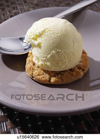 A scoop of ice cream on a chocolate chip cookie View Large Photo Image Stock Photograph - A scoop of ice cream on a chocolate chip cookie. Fotosearch