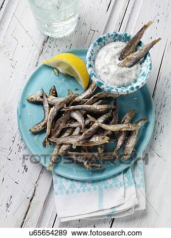 A single serving of deep fried whitebait with tartare sauce dip View Large Photo Image Stock Photo - A single serving of deep fried whitebait with tartare sauce dip. Fotosearch