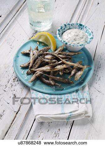 A single serving of deep fried whitebait with tartare sauce dip View Large Photo Image Stock Photo - A single serving of deep fried whitebait with tartare sauce dip. Fotosearch