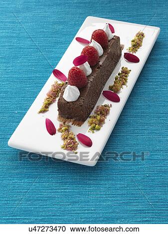 A whole chocolate marquis with raspberries and cream gourmet dessert View Large Photo Image Stock Image - A whole chocolate marquis with raspberries and cream gourmet dessert. Fotosearch
