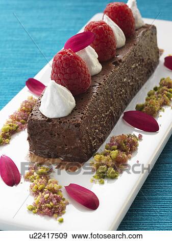 A whole chocolate marquise with raspberries and cream gourmet dessert View Large Photo Image Stock Photo - A whole chocolate marquise with raspberries and cream gourmet dessert. Fotosearch