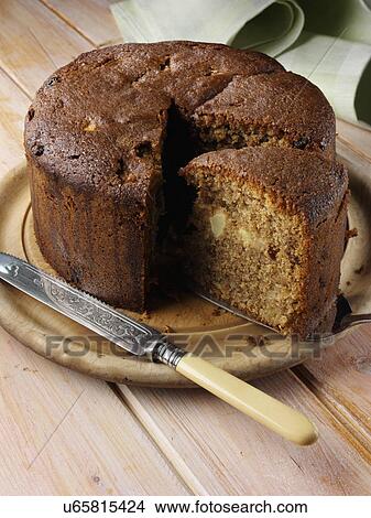 Picture - A whole Somerset apple cake with a slice. Fotosearch