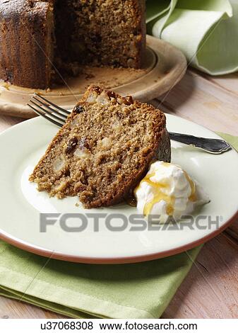 A whole Somerset apple cake with a slice on a plate in front with cream and honey View Large Photo Image Stock Photo - A whole Somerset apple cake with a slice on a plate in front with cream and honey. Fotosearch