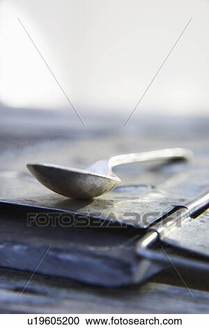 Stock Image - Abstract View Of Metal Spoon On Slate. Fotosearch