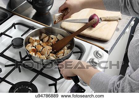 Adding spice to frying chicken View Large Photo Image Stock Photo - Adding spice to frying chicken. Fotosearch