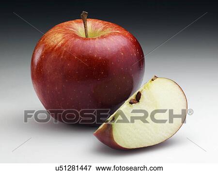Stock Photo - American Red Chief apple and a segment. Fotosearch