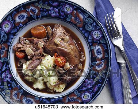 Stock Image - An antique plate of rabbit stew. Fotosearch
