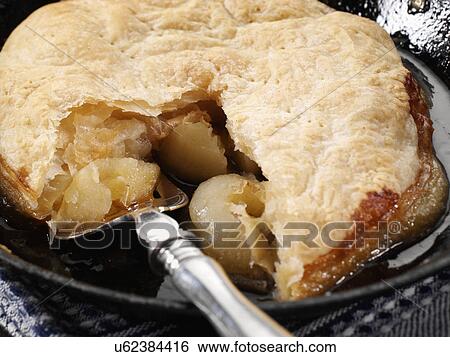 Stock Photograph - Apple pie cooking in pan. Fotosearch
