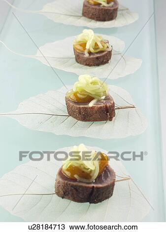 Stock Image - Asian tuna canapes with mango and cucumbers. Fotosearch