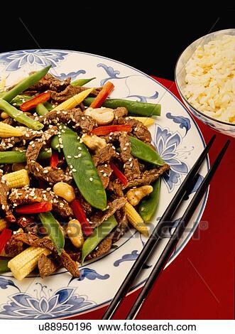 Beef Stir Fry Dish With Cashew Nut, Mange Tout, Baby Sweet Corn And Red Peppers, Chopsticks And Bowl Of Rice View Large Photo Image Stock Photograph - Beef Stir Fry Dish With Cashew Nut, Mange Tout, Baby Sweet Corn And Red Peppers, Chopsticks And Bowl Of Rice. Fotosearch