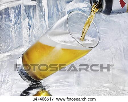 Beer can being poured into a glass View Large Photo Image Stock Photo - Beer can being poured into a glass. Fotosearch