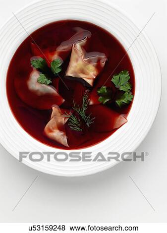 Stock Photo - Beetroot soup with pierogi dumplings. Fotosearch