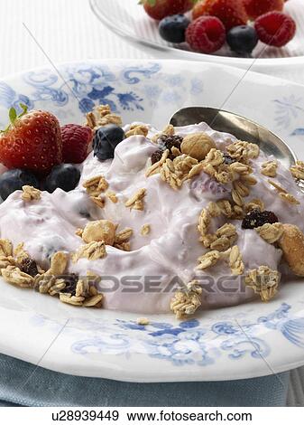 Stock Photo - Berry yoghourt with fresh ripe fruit strawberries raspberries blueberries. Fotosearch