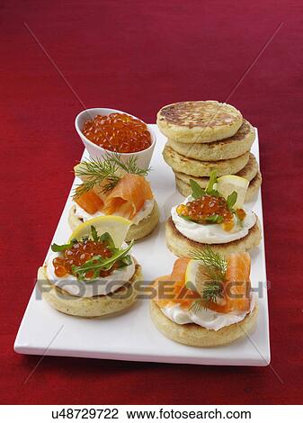 Blini with smoked salmon salmon roe and cream cheese View Large Photo Image Stock Image - Blini with smoked salmon salmon roe and cream cheese. Fotosearch