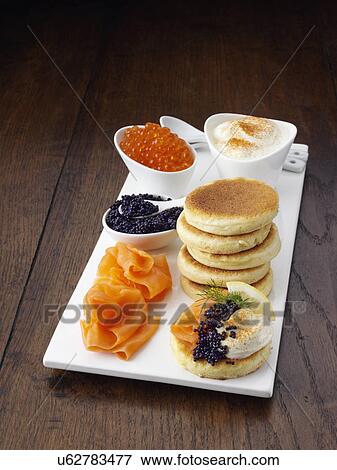Stock Photo - Blini with smoked salmon salmon roe and sour cream. Fotosearch