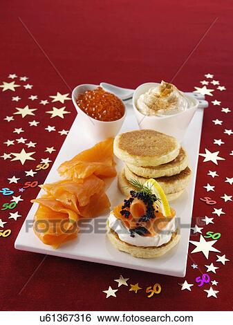 Stock Photograph - Blini with smoked salmon salmon roe and cream cheese. Fotosearch