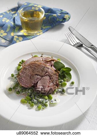 Boned roast leg of lamb slices with creamy peas and broad beans View Large Photo Image Stock Image - Boned roast leg of lamb slices with creamy peas and broad beans. Fotosearch