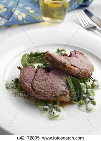 Boned roast leg of lamb slices with creamy peas and broad beans View Large Photo Image Stock Photography - Boned roast leg of lamb slices with creamy peas and broad beans. Fotosearch