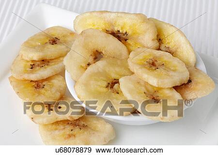 Stock Photo - Bowl Of Dried Banana Chips On White. Fotosearch