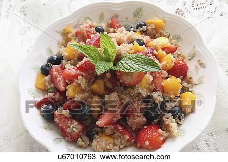 Stock Image - Bowl Of Quinoa Served With Summer Fruits. Fotosearch