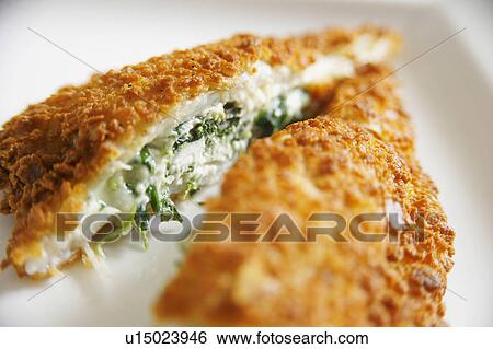 Stock Photograph - Breaded Stuffed Fish Cut Open On Plate. Fotosearch