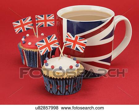 British Themed Celebration Cupcakes, White And Red Iced Sponge Fairy Or Cup Cake, Topped With Red, White And Blue Sprinkles, Small Union Jack Flags, Union Jack Mug Of Tea, All On Red Background View Large Photo Image Stock Photo - British Themed Celebration Cupcakes, White And Red Iced Sponge Fairy Or Cup Cake, Topped With Red, White And Blue Sprinkles, Small Union Jack Flags, Union Jack Mug Of Tea, All On Red Background. Fotosearch