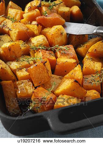 Stock Photograph - Butternut squash chunks baked with thyme. Fotosearch
