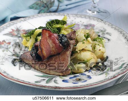 Stock Image - Calves liver with devils on horseback cabbage and potatoes. Fotosearch