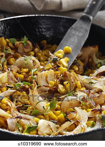 Stock Image - caramelized corn with shallots. Fotosearch