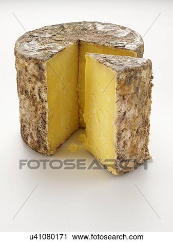 Stock Image - Cave aged traditional cloth wrapped mature cheddar cheese. Fotosearch