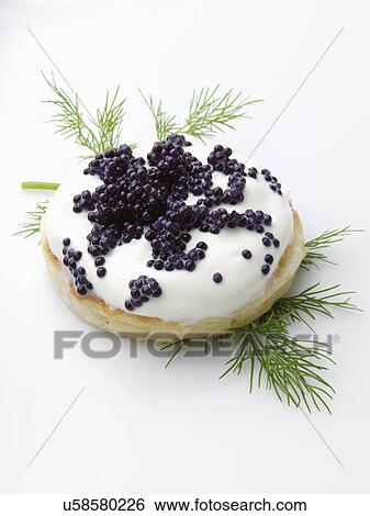 Stock Photograph - Caviar sour cream dill blini. Fotosearch